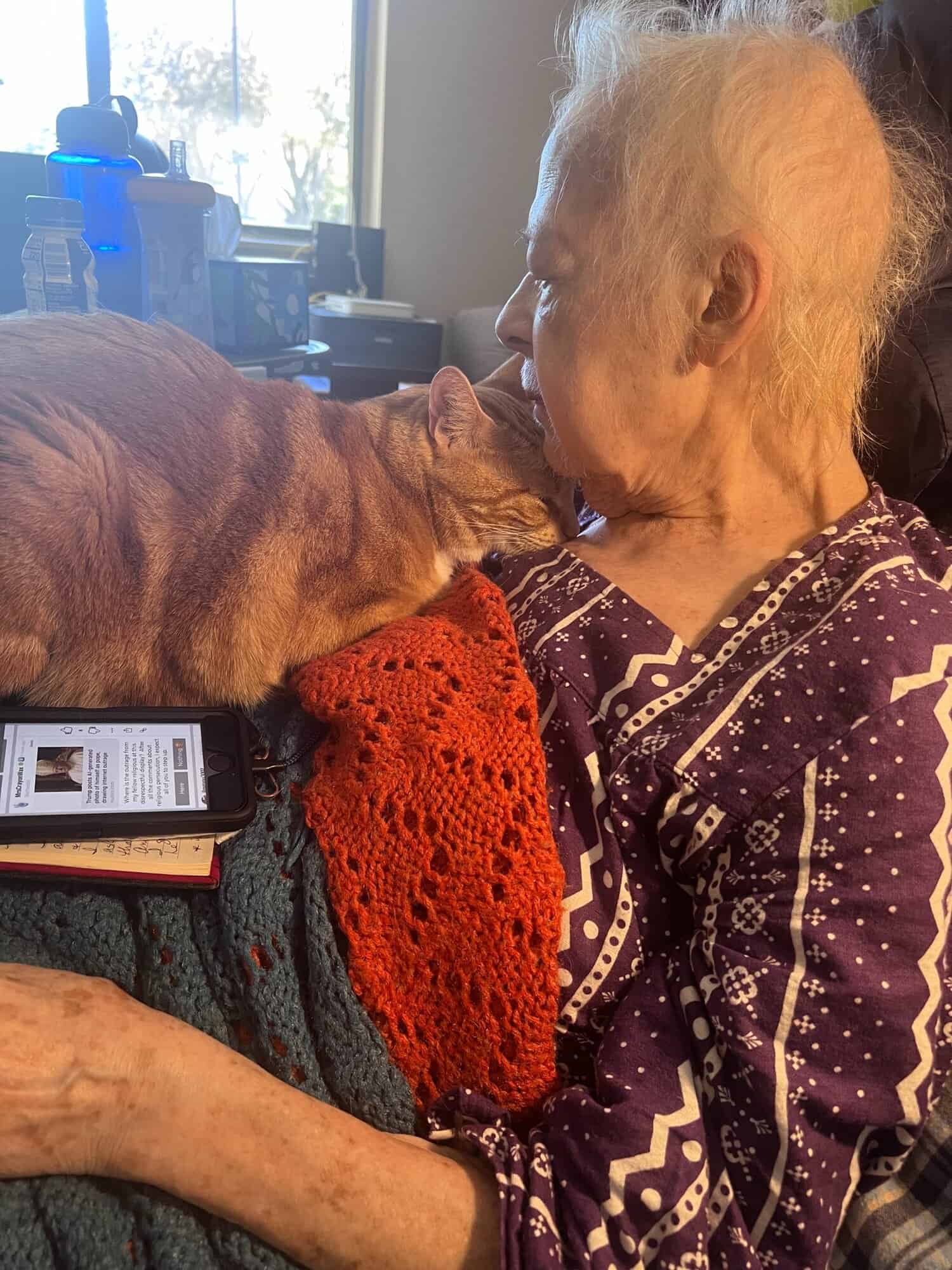 Susan Robbins snuggling with an orange cat