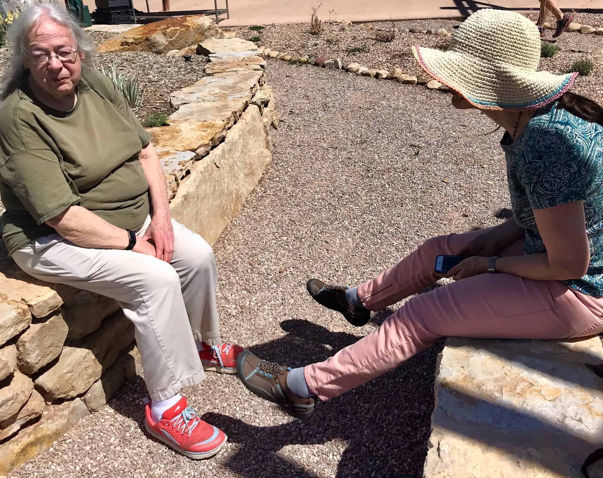 Susan and Rachel sitting facing each other at The Gardens on Spring Creek