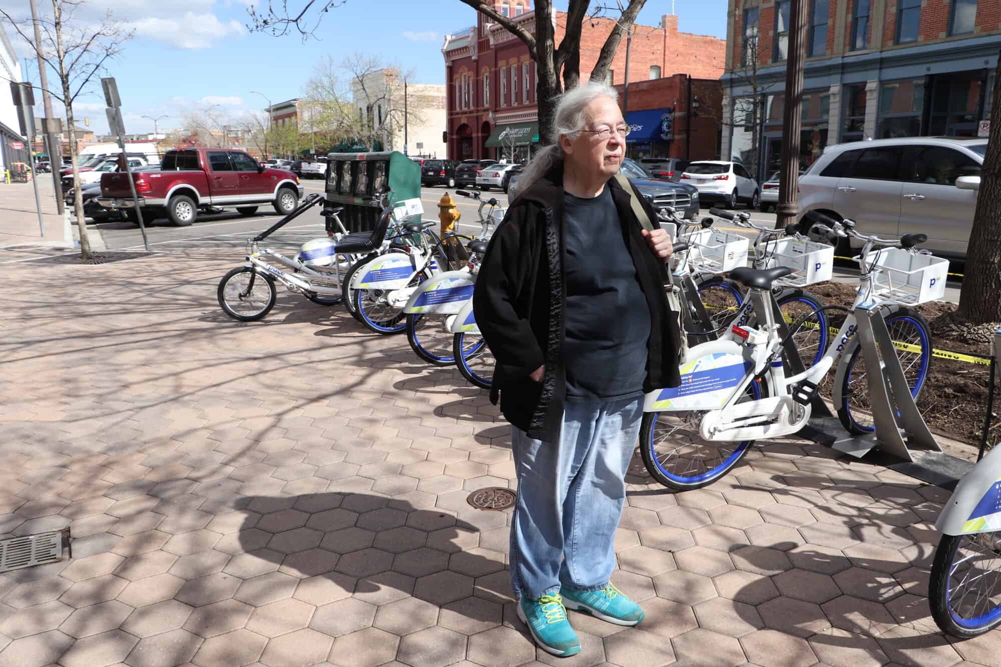 Susan standing in front of bicycles in Old Town Fort Collins
