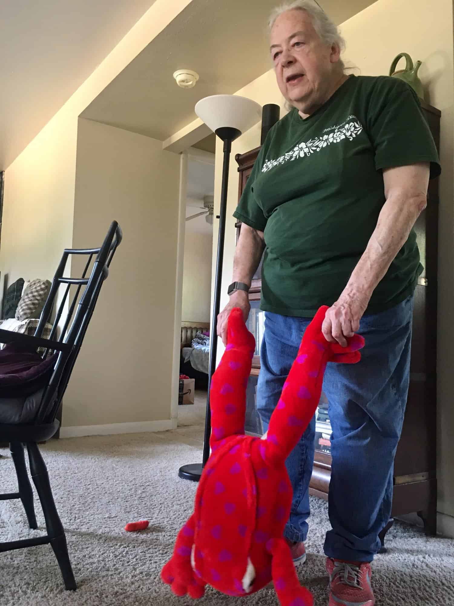 Susan holding a large, red stuffed toy frog