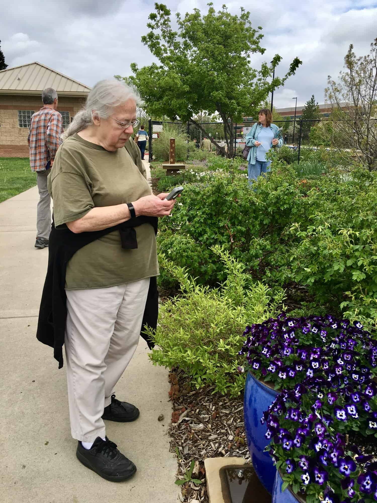 Susan looking at plants at The Gardens on Spring Creek