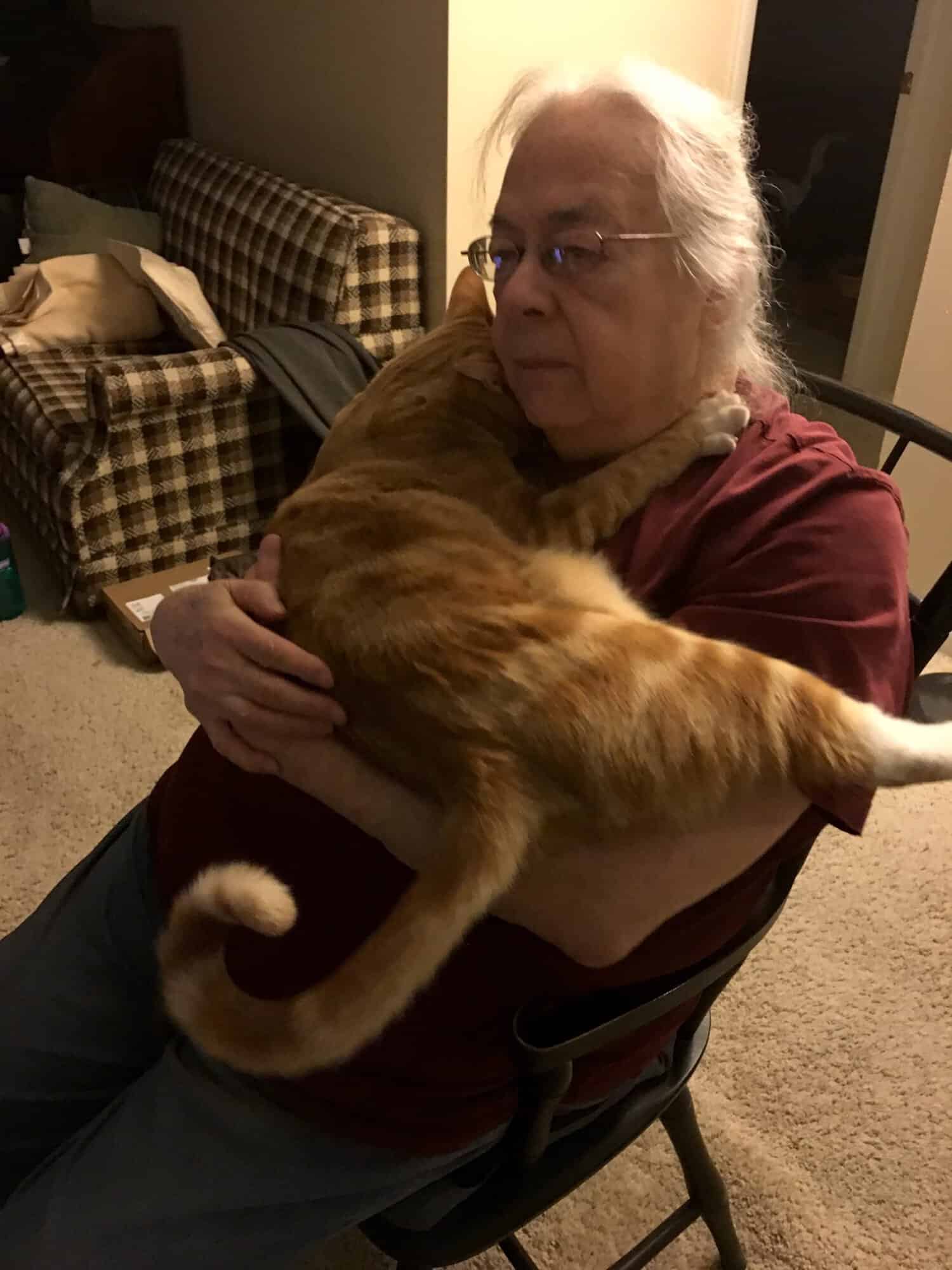 Susan holding Butters, who is hugging her neck