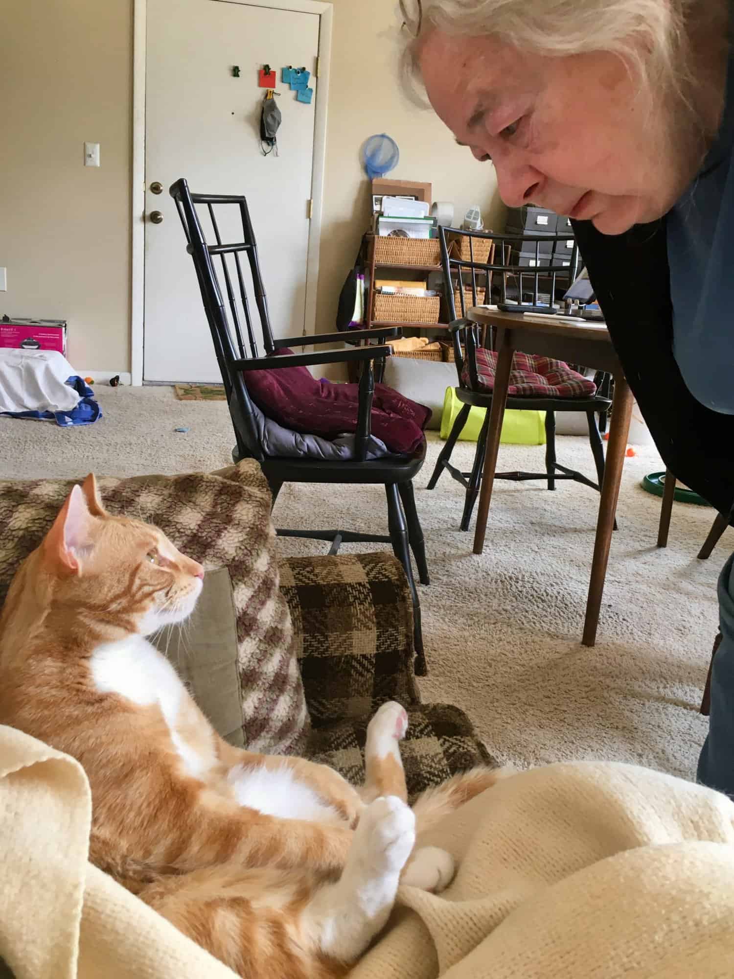 Susan standing looking down at Butters, who is sitting in a goofy position on the couch