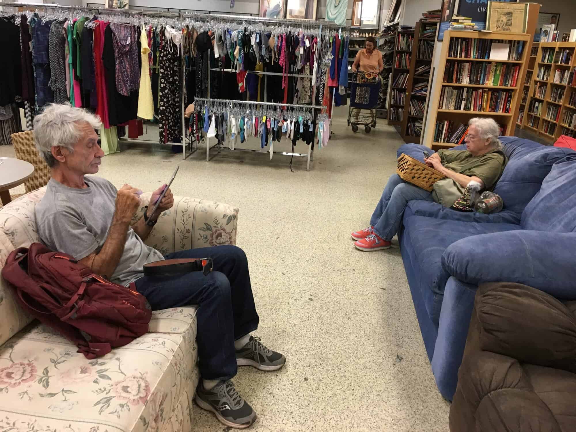 Michael and Susan sitting on couches in a thrift store
