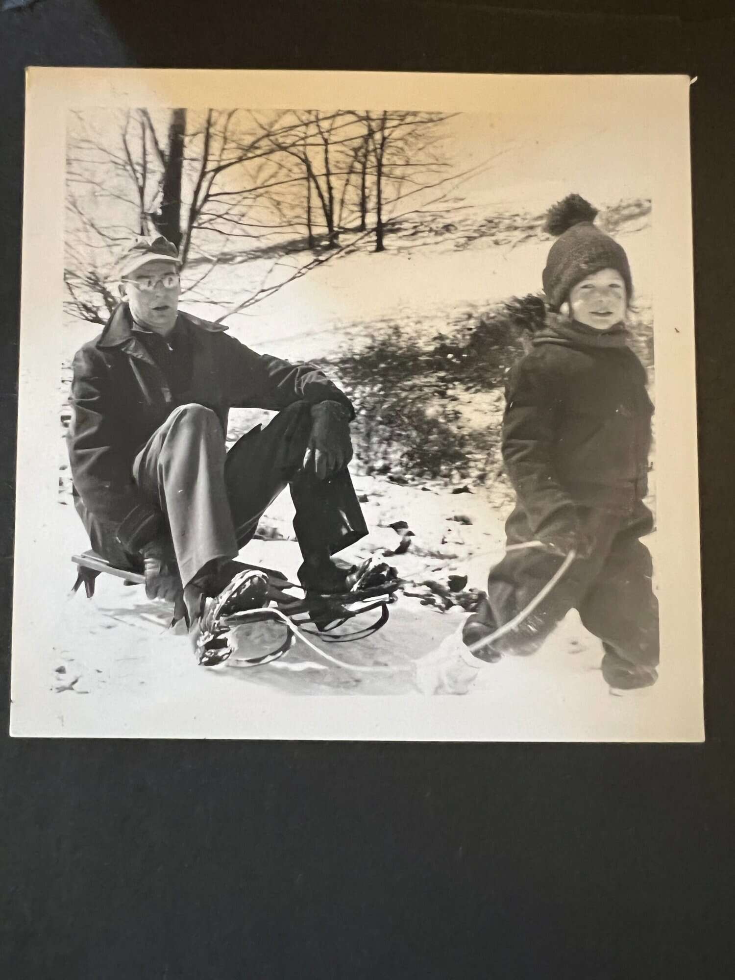 Susan pulling her father on a sled