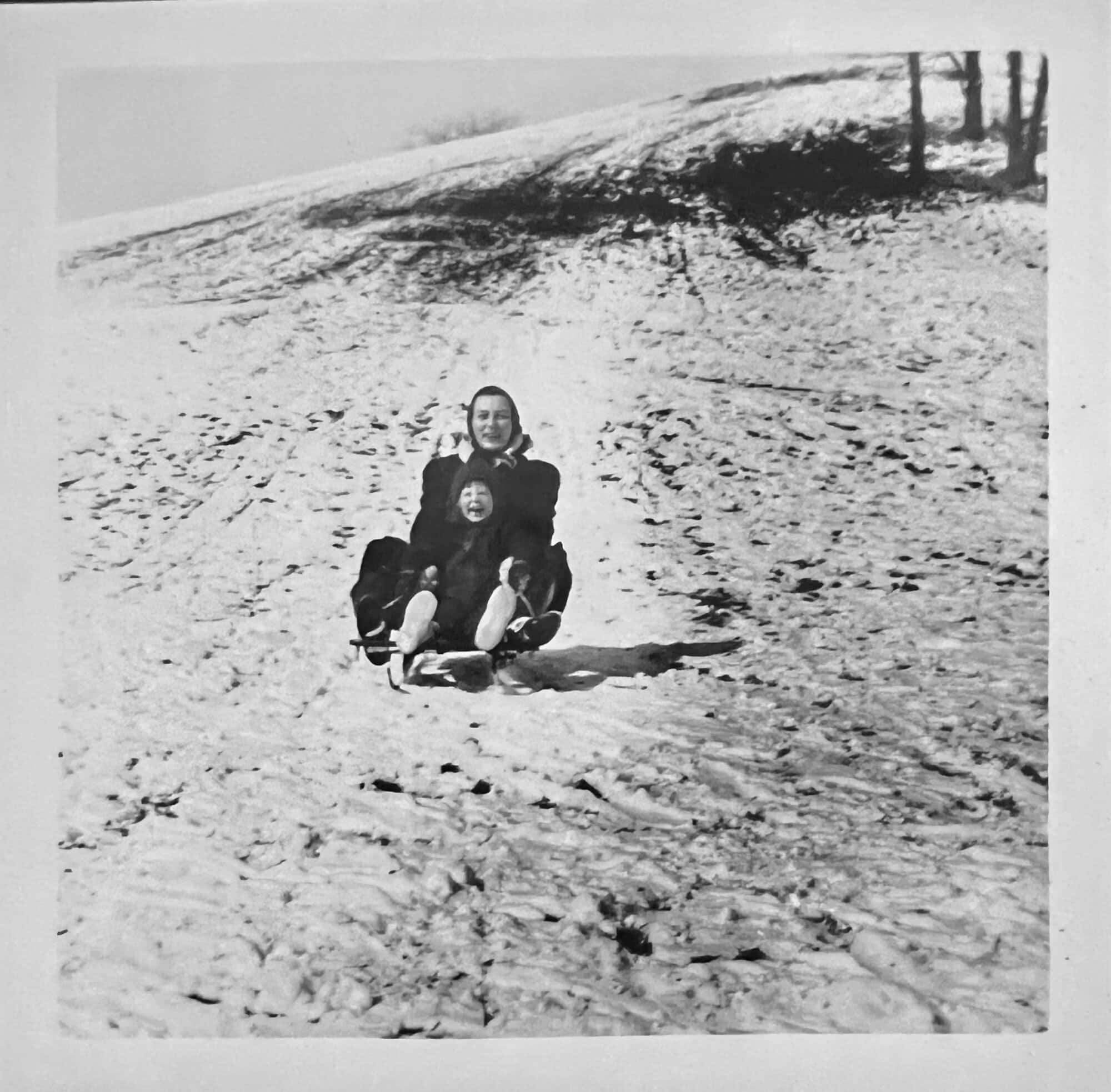 Susan's mother and Susan sledding