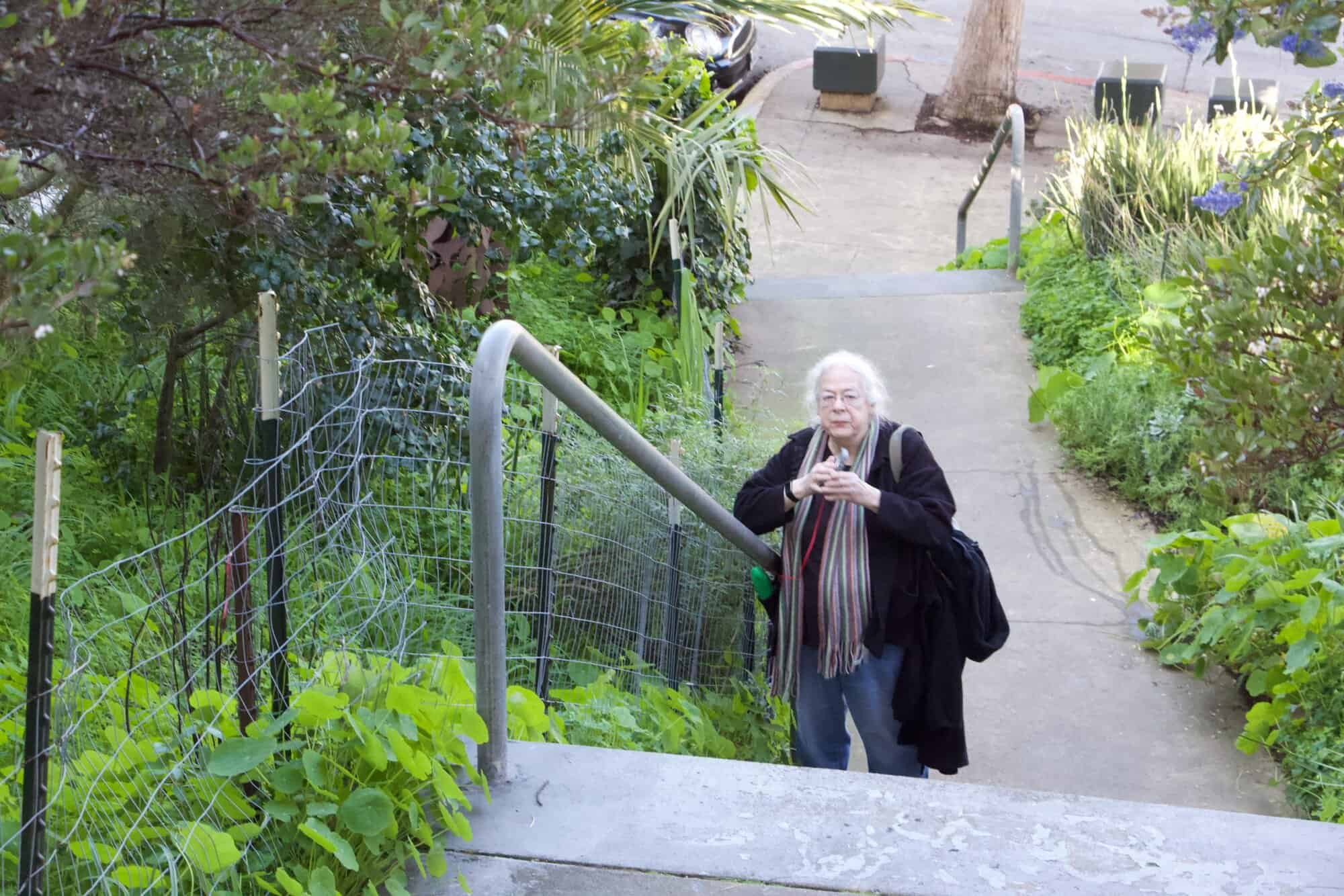 Susan walking up stairs in a San Francisco neighborhood